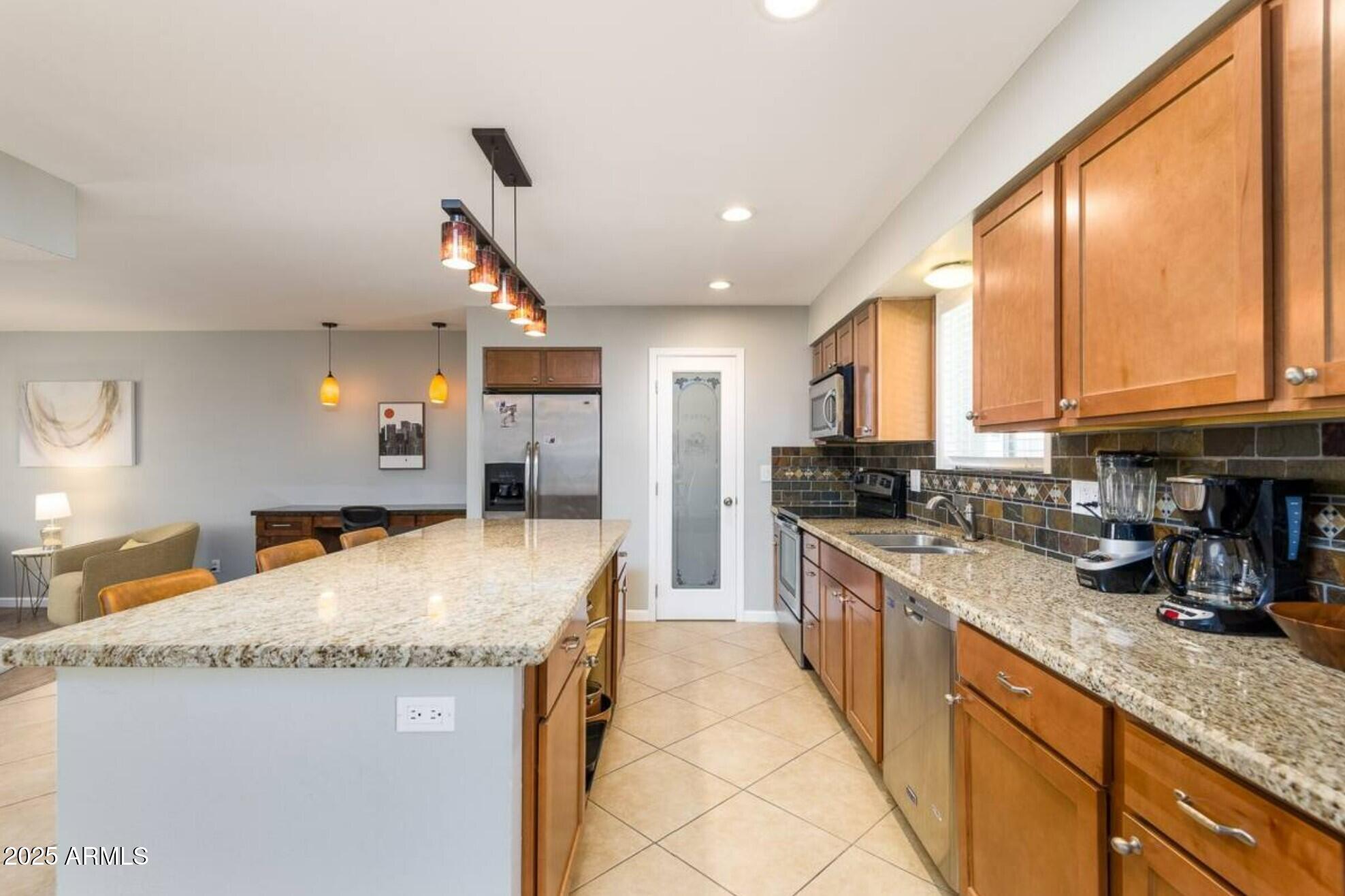 1612 West Geneva Drive Tempe, AZ 85282 - Photo 10 of 36 a kitchen with stainless steel appliances granite countertop sink stove and refrigerator