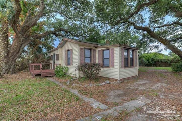 1717 West Government Street Pensacola, FL 32502 - Photo 1 of 11 a white house that has a tree in front of it