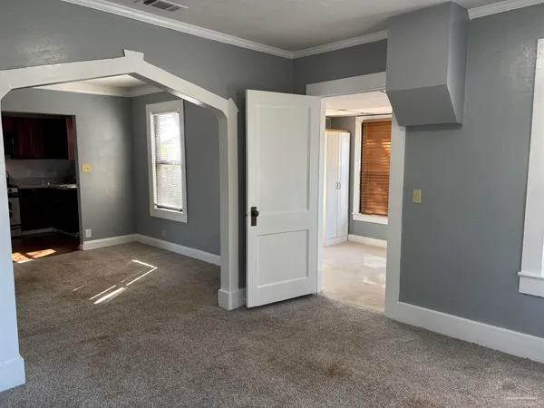 an empty room with windows and entrance