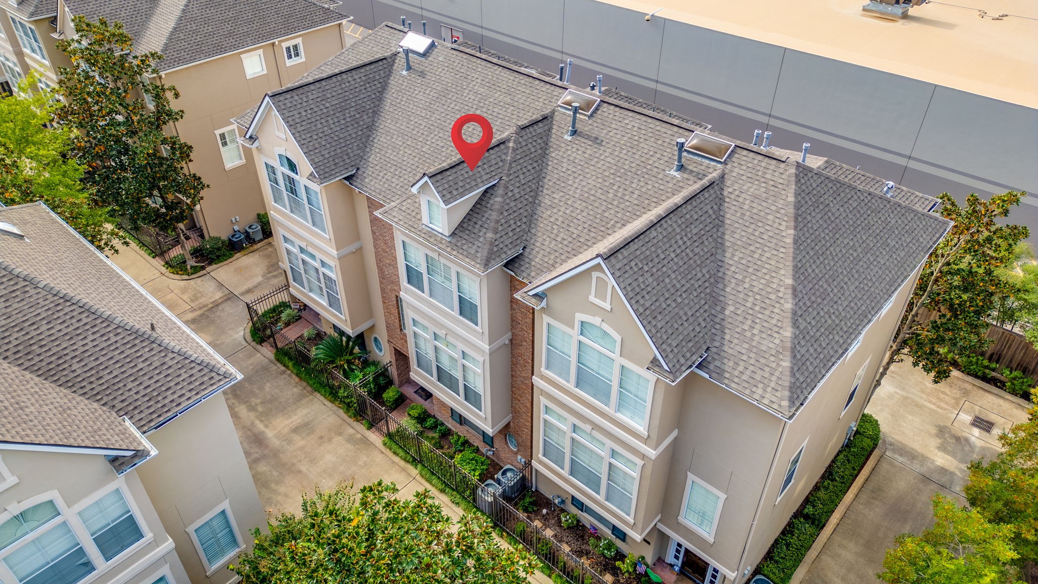 2196 Bancroft Lane Houston, TX 77027 - Photo 3 of 30 From above, the drone view showcases the townhome’s layout and well-maintained exterior, highlighting its prime location.