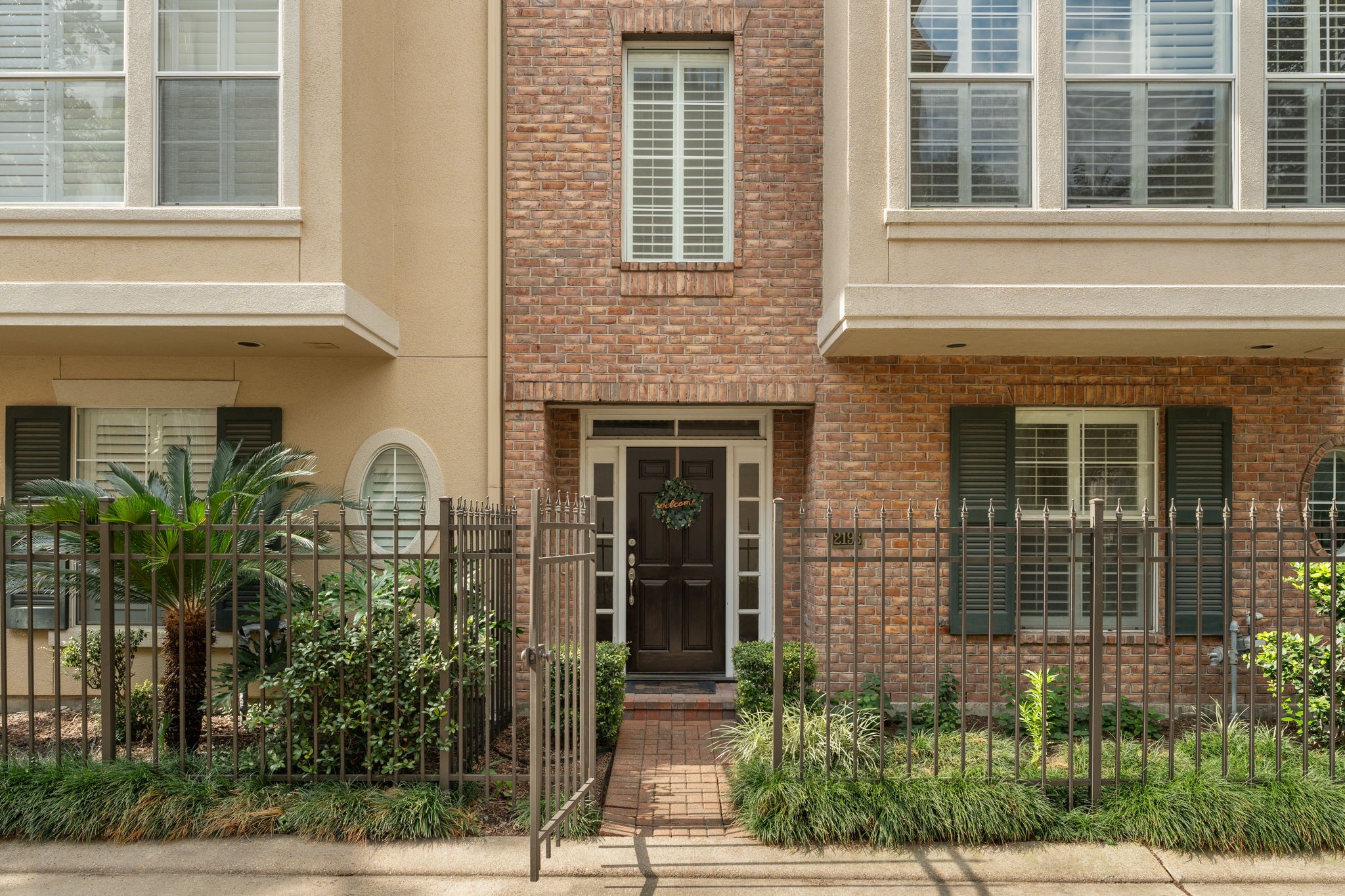 2196 Bancroft Lane Houston, TX 77027 - Photo 4 of 30 This charming well maintained 3 bed, 3 and a half bath townhome featuring classic brick elevation, charming iron-gated entry, and lush landscaping that creates a warm and inviting first impression.