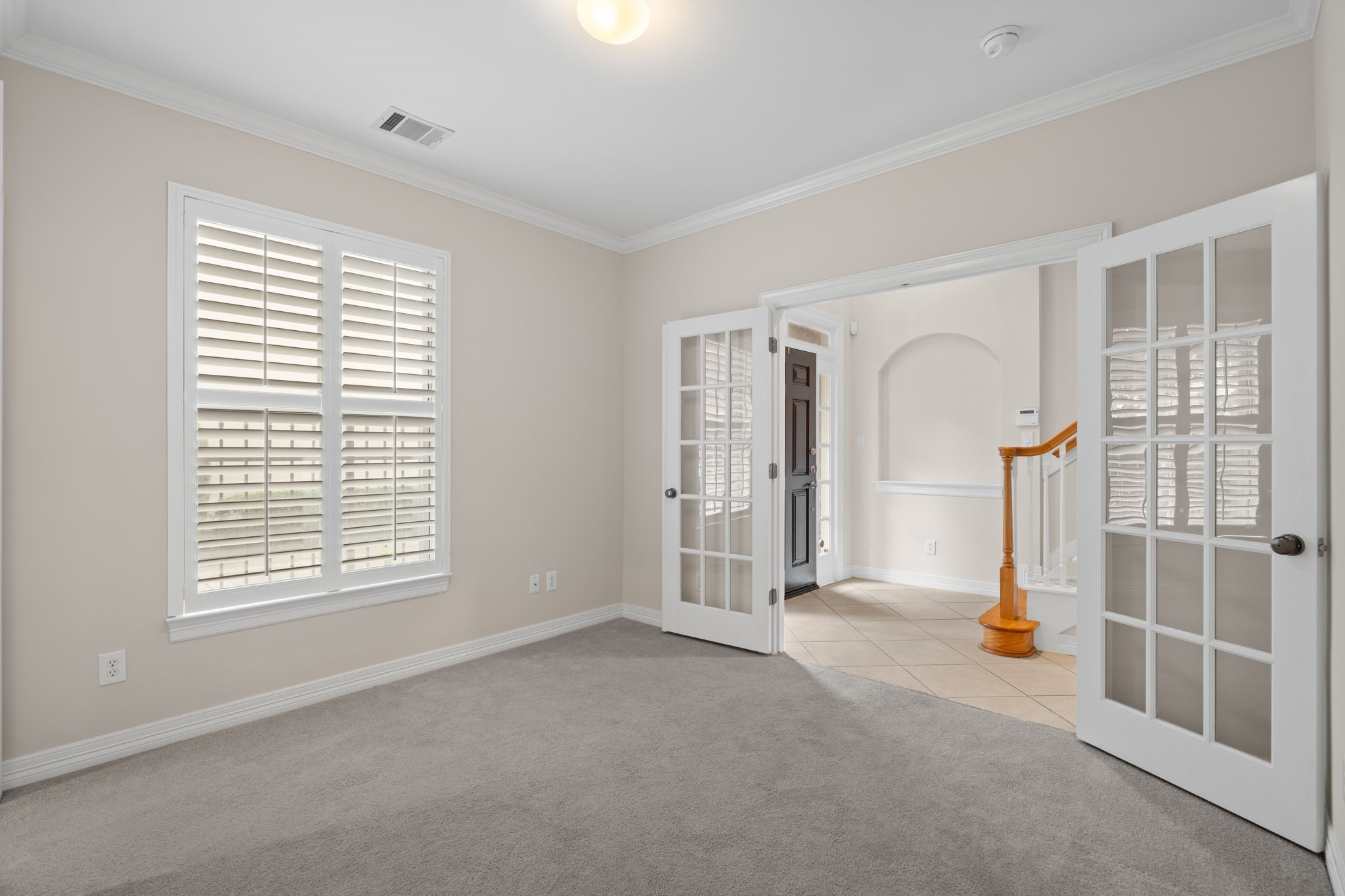 2196 Bancroft Lane Houston, TX 77027 - Photo 6 of 30 The secondary bedroom features elegant crown molding and plush carpet.
