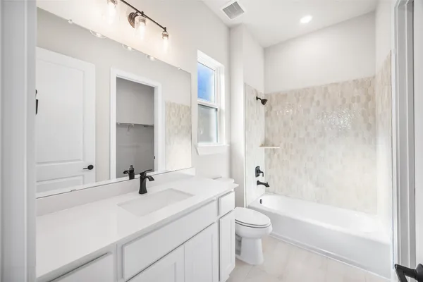 a kitchen with kitchen island granite countertop a sink a counter and stainless steel appliances