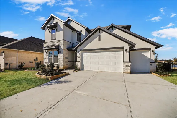 a kitchen with stainless steel appliances granite countertop a large counter top and a view of living room