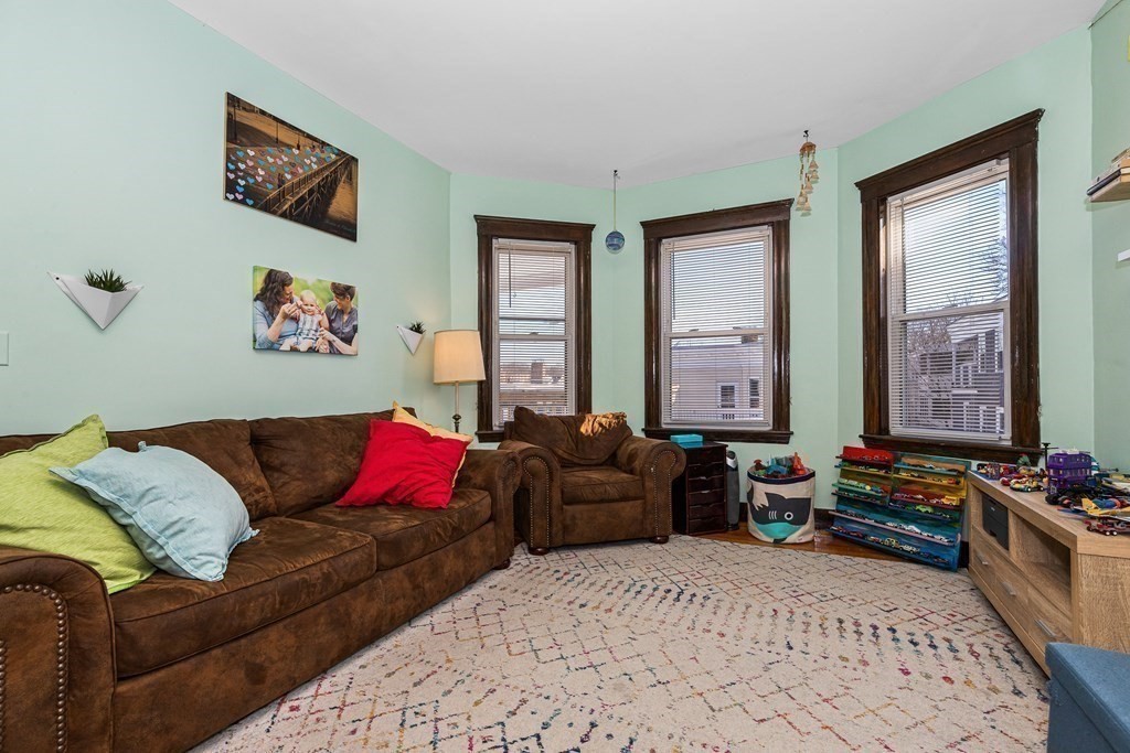87 Parkton Road Boston, MA 02130 - Photo 13 of 42 a living room with furniture couch and a window