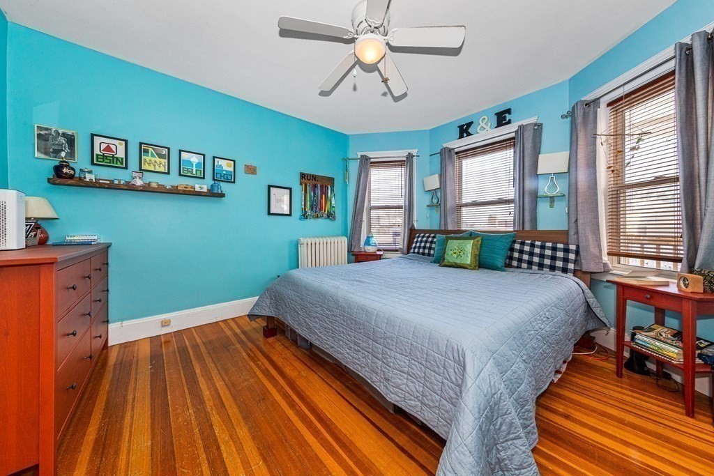 87 Parkton Road Boston, MA 02130 - Photo 14 of 42 a bedroom with a bed and a chandelier