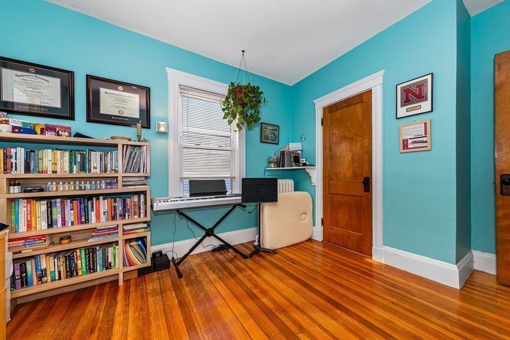 87 Parkton Road Boston, MA 02130 - Photo 15 of 42 a living room with furniture and a book shelf