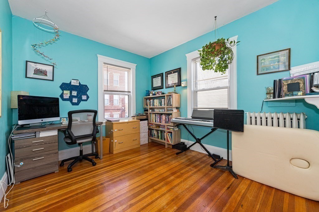 87 Parkton Road Boston, MA 02130 - Photo 16 of 42 a living room with furniture a flat screen tv and a wooden floor