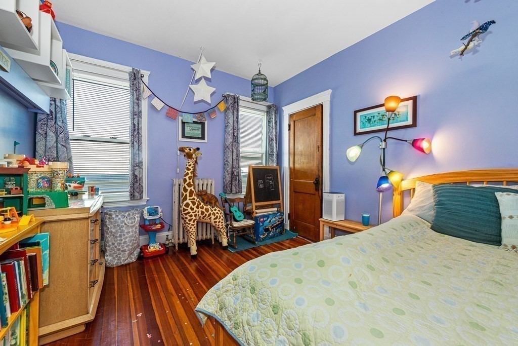 87 Parkton Road Boston, MA 02130 - Photo 18 of 42 a bedroom with a bed and wooden floor