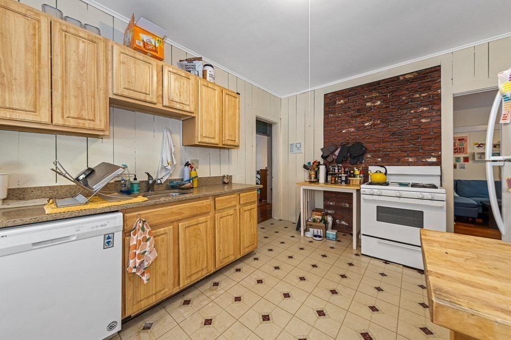87 Parkton Road Boston, MA 02130 - Photo 20 of 42 a kitchen with stainless steel appliances a stove a sink and a refrigerator