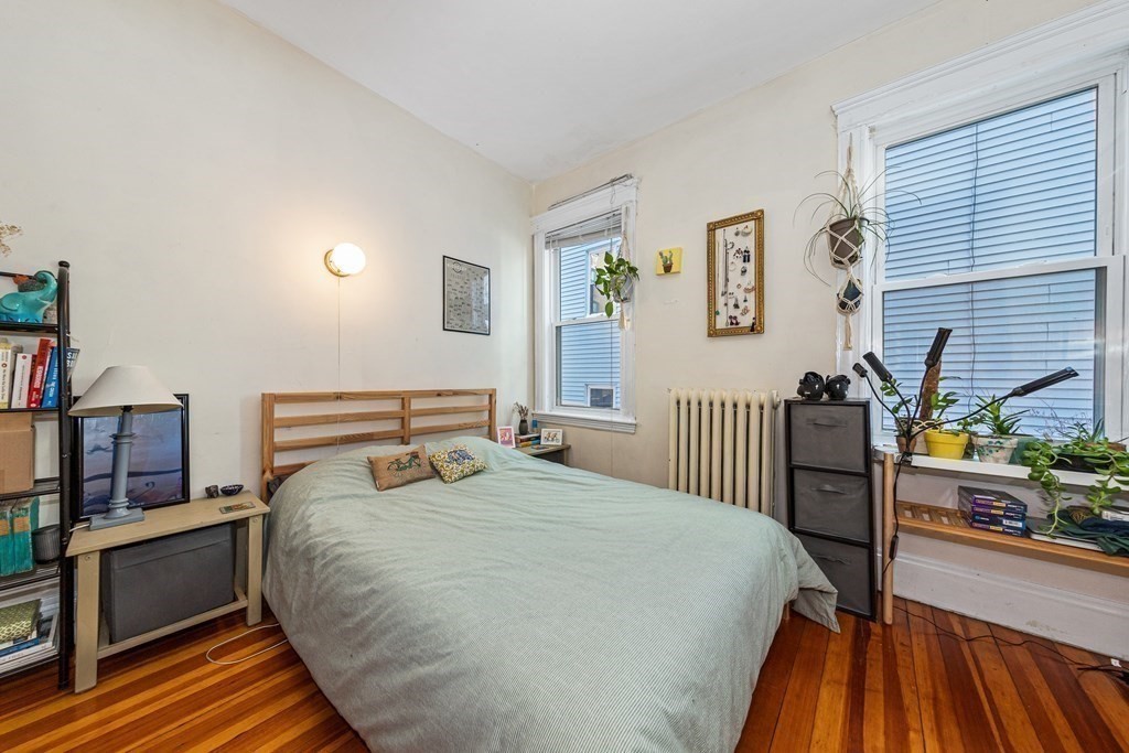 87 Parkton Road Boston, MA 02130 - Photo 27 of 42 a bedroom with a bed and a book shelf