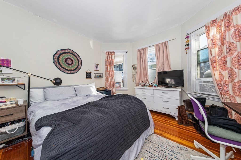 87 Parkton Road Boston, MA 02130 - Photo 28 of 42 a bedroom with a bed and a flat screen tv