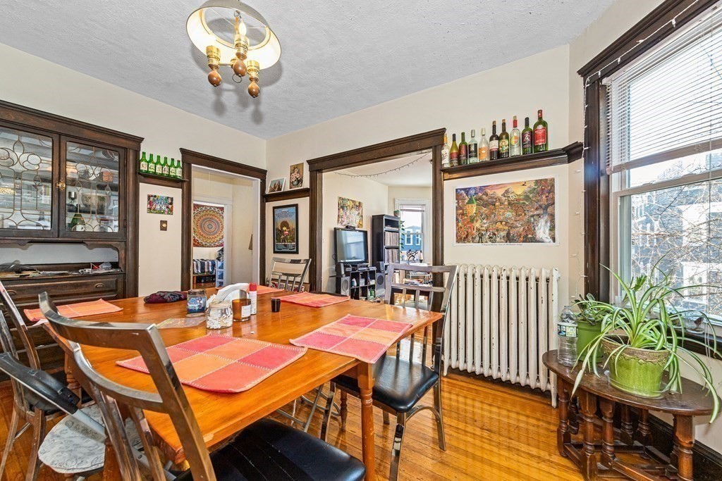 87 Parkton Road Boston, MA 02130 - Photo 32 of 42 a dining room with furniture a window and wooden floor