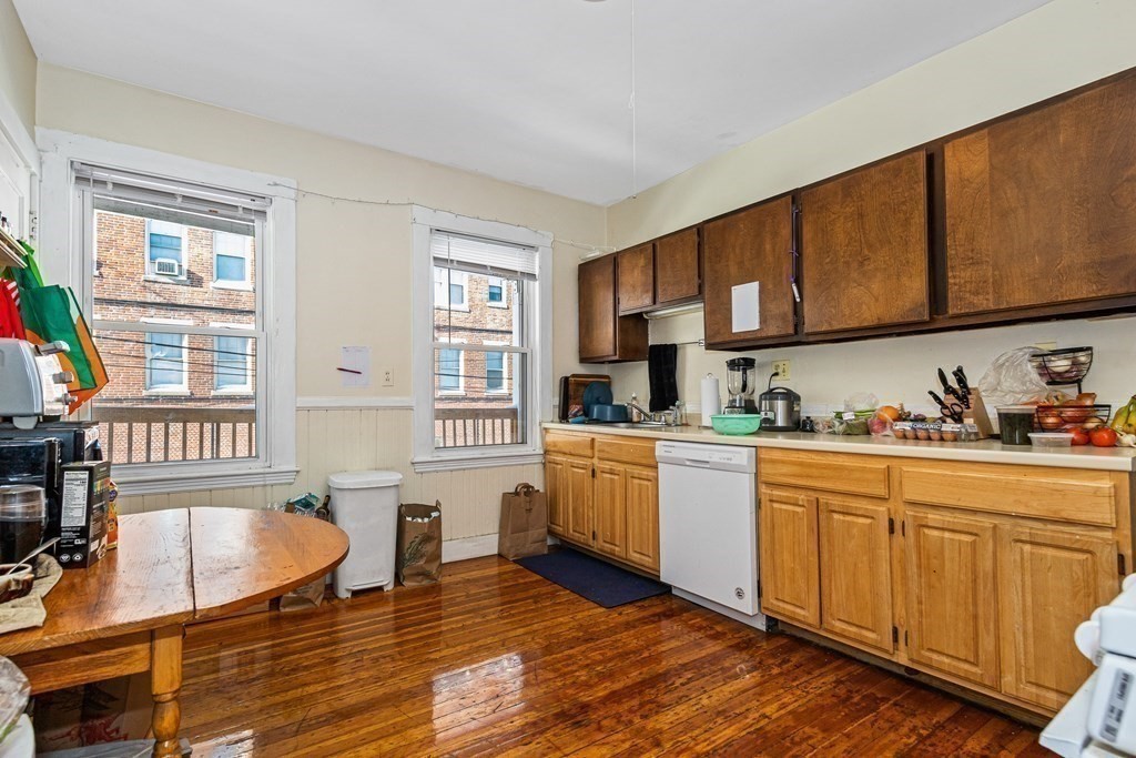 87 Parkton Road Boston, MA 02130 - Photo 35 of 42 a kitchen with stainless steel appliances granite countertop a stove a sink dishwasher and cabinets with wooden floor