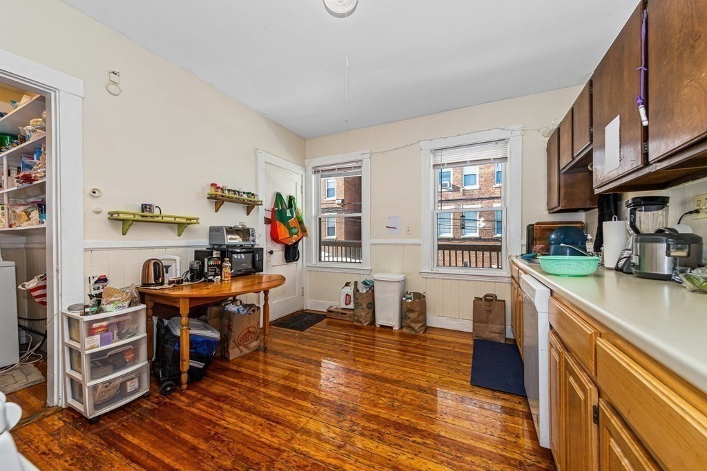 87 Parkton Road Boston, MA 02130 - Photo 37 of 42 a view of a kitchen filled with furniture and wooden floor