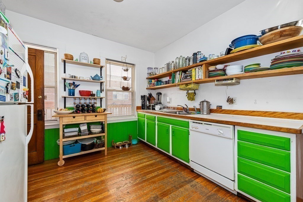 87 Parkton Road Boston, MA 02130 - Photo 5 of 42 a kitchen with cabinets a sink and a stove