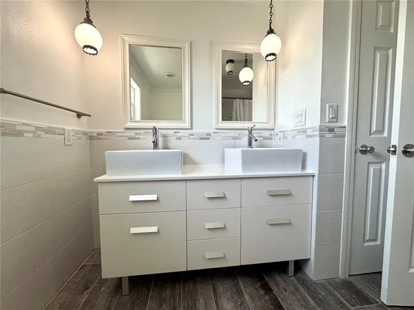 a bathroom with a double vanity sink and mirror