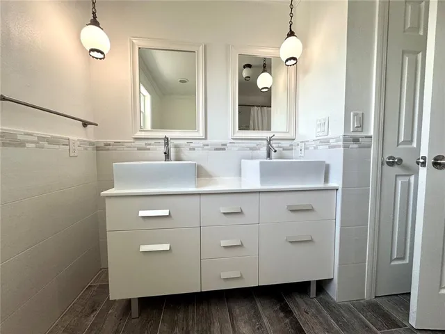 a bathroom with a double vanity sink and mirror