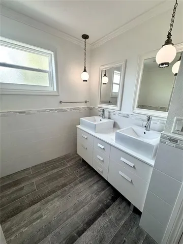 a bathroom with a double vanity sink and mirror