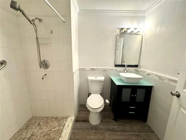 a bathroom with a sink toilet and shower