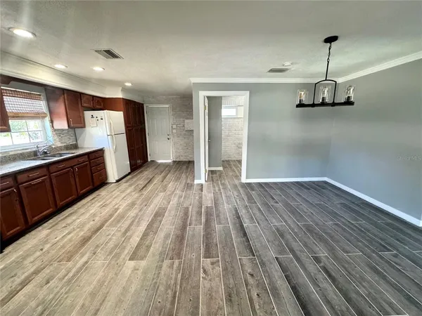 a view of a room with wooden floor and window
