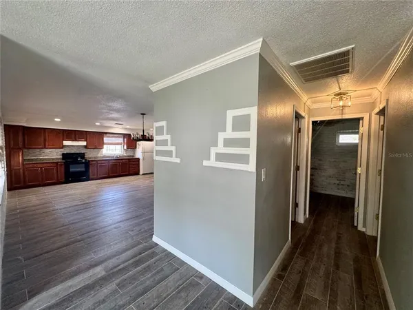 a view of kitchen with refrigerator and stove