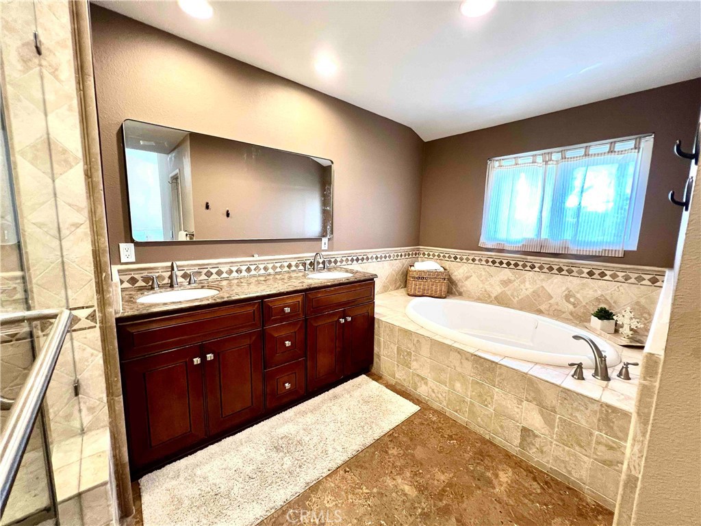 500 Silver Canyon Way Brea, CA 92821 - Photo 14 of 24 a spacious bathroom with a tub sink and mirror