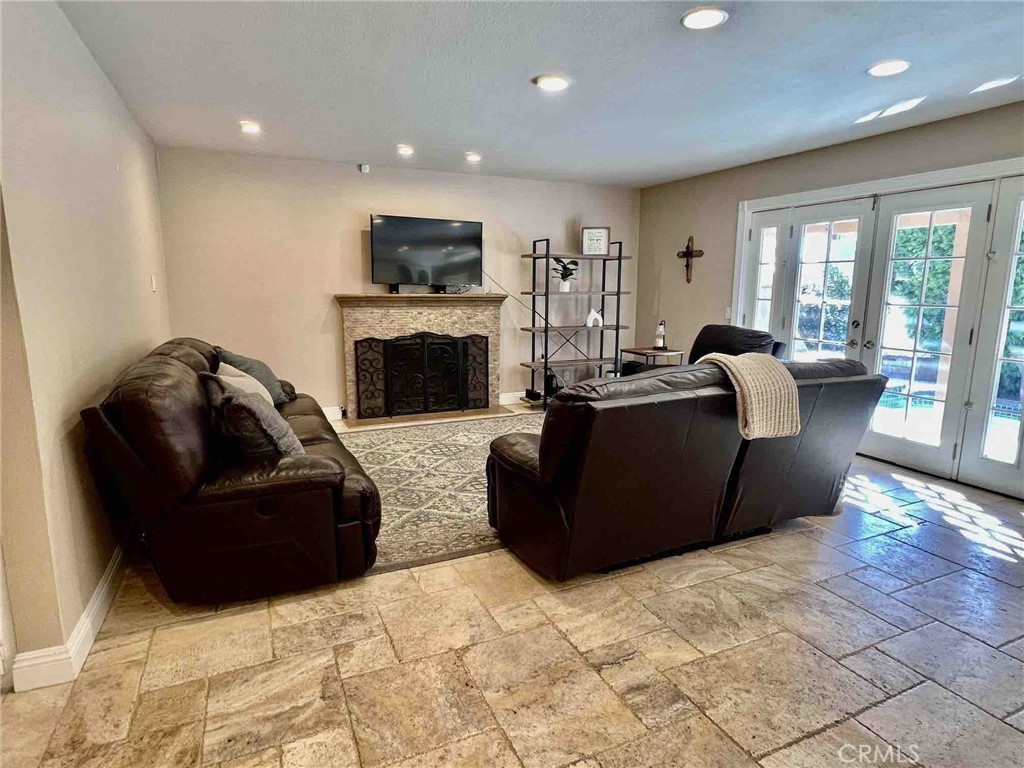 500 Silver Canyon Way Brea, CA 92821 - Photo 4 of 24 a living room with furniture a fireplace and a flat screen tv