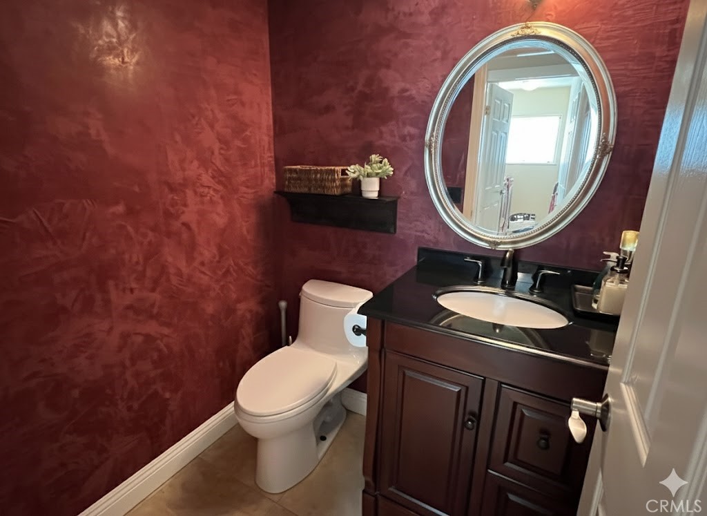 500 Silver Canyon Way Brea, CA 92821 - Photo 9 of 24 a bathroom with a toilet a sink and a mirror