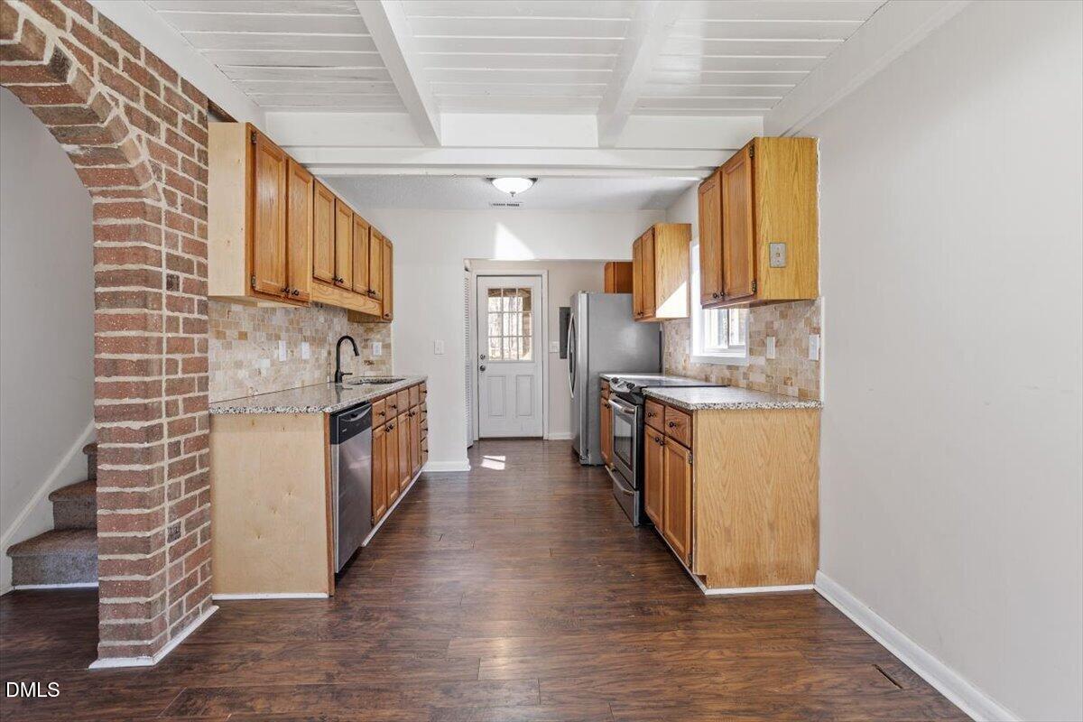 1423 Alderman Circle Raleigh, NC 27603 - Photo 23 of 37 a kitchen with stainless steel appliances granite countertop a sink and cabinets