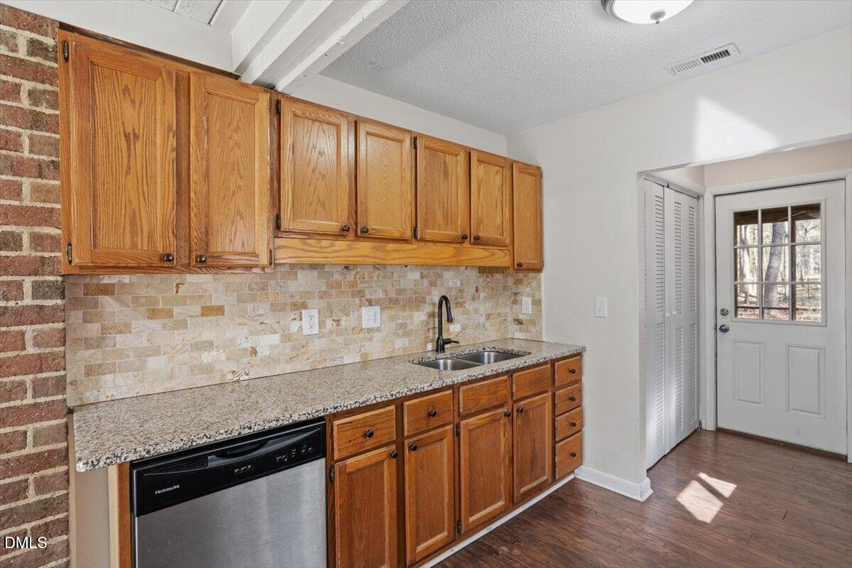 1423 Alderman Circle Raleigh, NC 27603 - Photo 25 of 37 a kitchen with granite countertop stainless steel appliances a sink window and cabinets