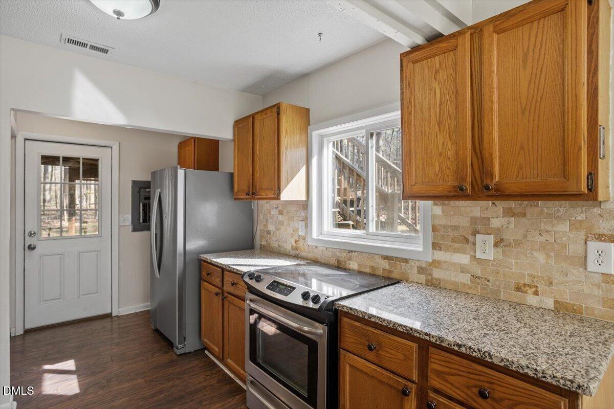 1423 Alderman Circle Raleigh, NC 27603 - Photo 26 of 37 a kitchen with stainless steel appliances granite countertop a refrigerator stove and sink