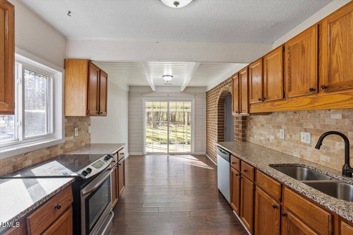 1423 Alderman Circle Raleigh, NC 27603 - Photo 27 of 37 a kitchen with a stove a sink and a refrigerator