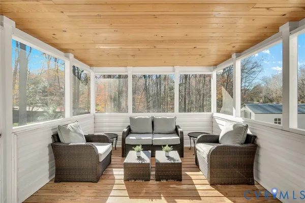 a living room with furniture and large windows