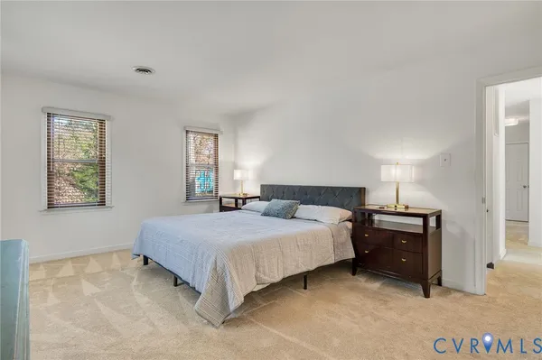 a bedroom with a bed and a lamp
