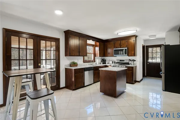 a kitchen with a sink refrigerator and cabinets