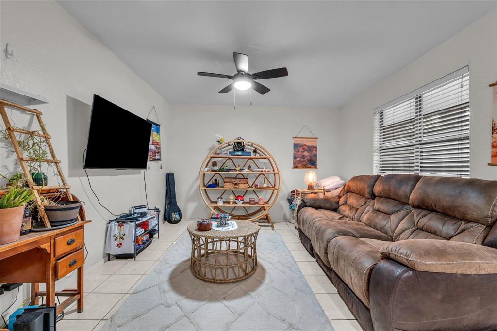 1421 South 12th Street, Unit 103 Waco, TX 76706 - Photo 4 of 17 a living room with furniture a flat screen tv and a window