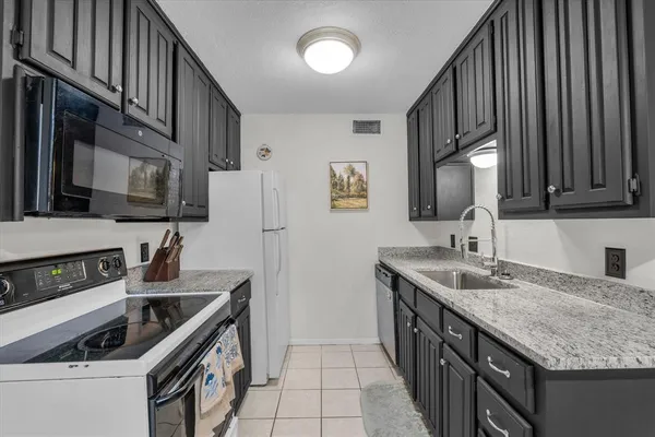 a kitchen that has a sink and a stove