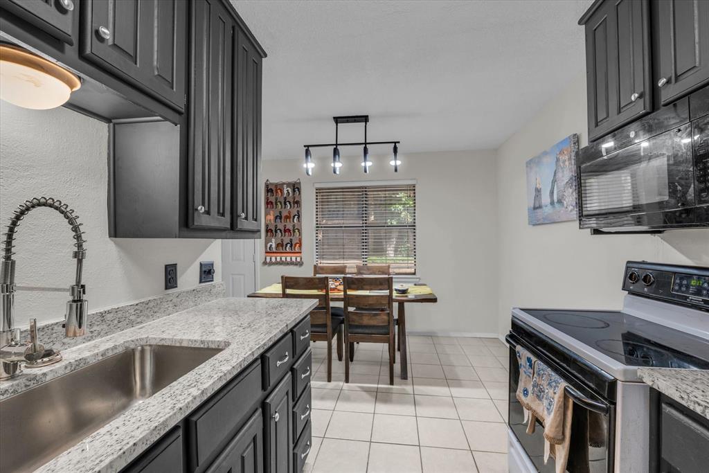 1421 South 12th Street, Unit 103 Waco, TX 76706 - Photo 8 of 17 a kitchen that has a sink and a stove