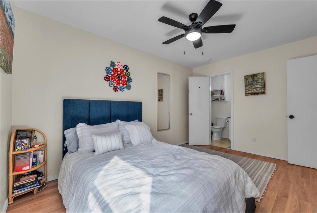 1421 South 12th Street, Unit 103 Waco, TX 76706 - Photo 10 of 17 a bedroom with a bed and a chandelier