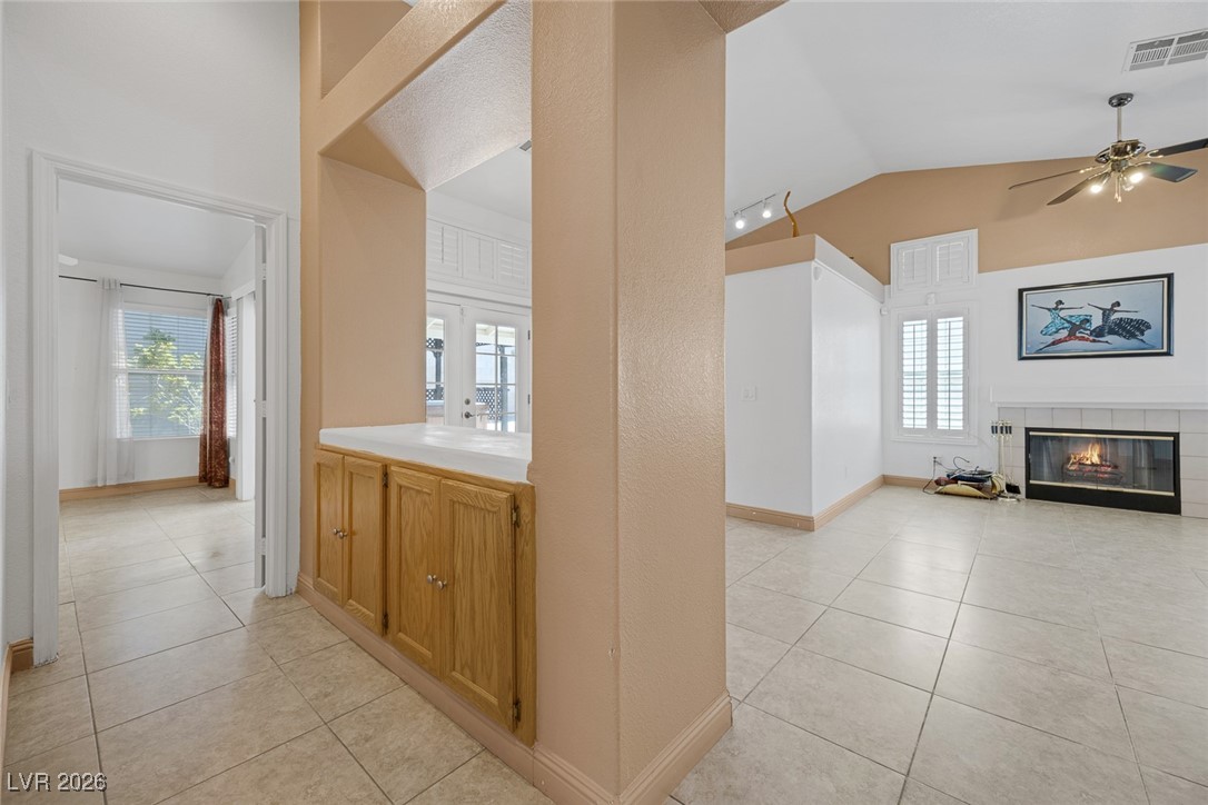 2427 Worchester Road Henderson, NV 89074 - Photo 17 of 35 Hall with light tile patterned floors, plenty of natural light, and lofted ceiling