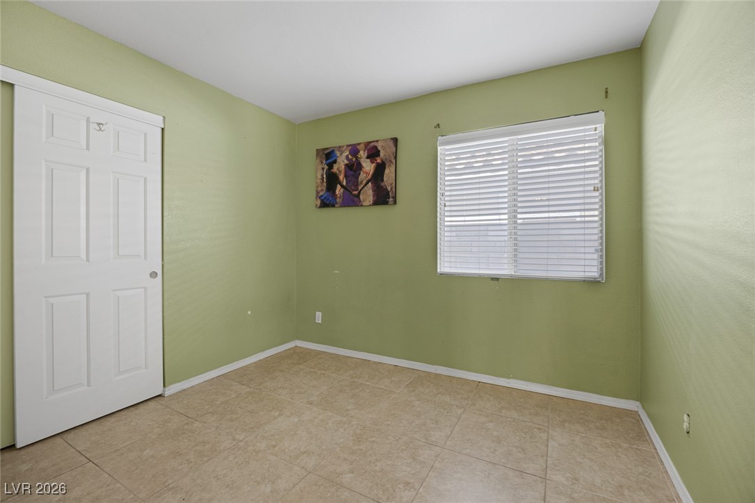 2427 Worchester Road Henderson, NV 89074 - Photo 22 of 35 Unfurnished bedroom with baseboards and light tile patterned floors