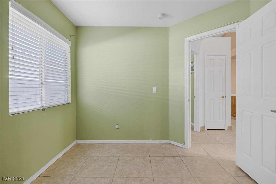 2427 Worchester Road Henderson, NV 89074 - Photo 23 of 35 Unfurnished room featuring light tile patterned floors and baseboards