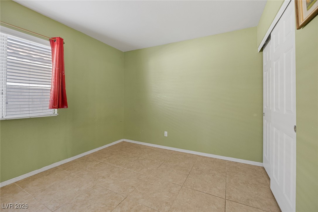 2427 Worchester Road Henderson, NV 89074 - Photo 25 of 35 Unfurnished bedroom featuring baseboards and a closet