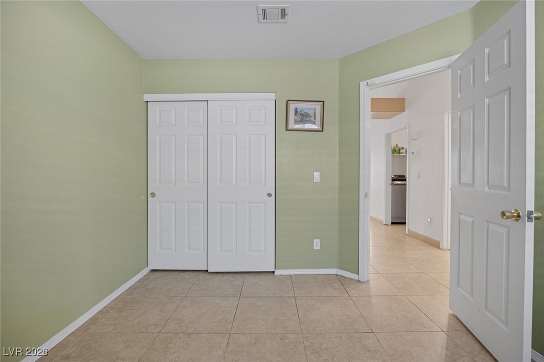 2427 Worchester Road Henderson, NV 89074 - Photo 26 of 35 Unfurnished bedroom featuring a closet and light tile patterned floors