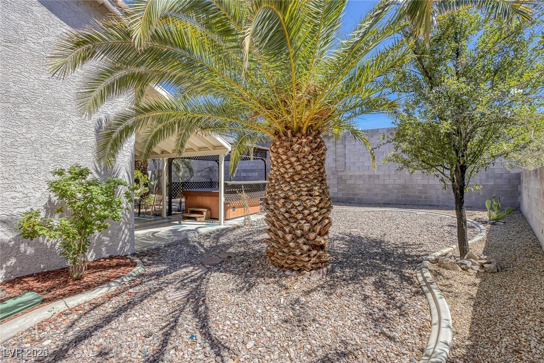 2427 Worchester Road Henderson, NV 89074 - Photo 29 of 35 Fenced backyard featuring a hot tub and a patio area