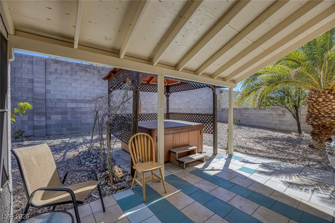 2427 Worchester Road Henderson, NV 89074 - Photo 33 of 35 Fenced backyard featuring a hot tub and a patio area