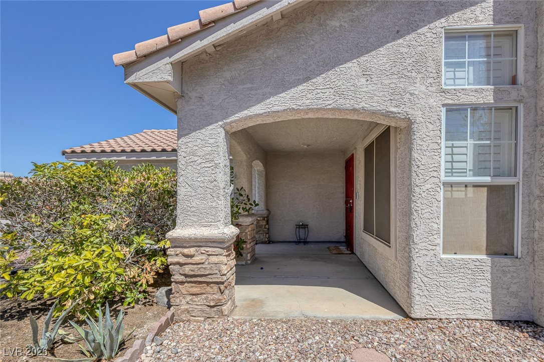 2427 Worchester Road Henderson, NV 89074 - Photo 5 of 35 Doorway to property with stucco siding and a tiled roof