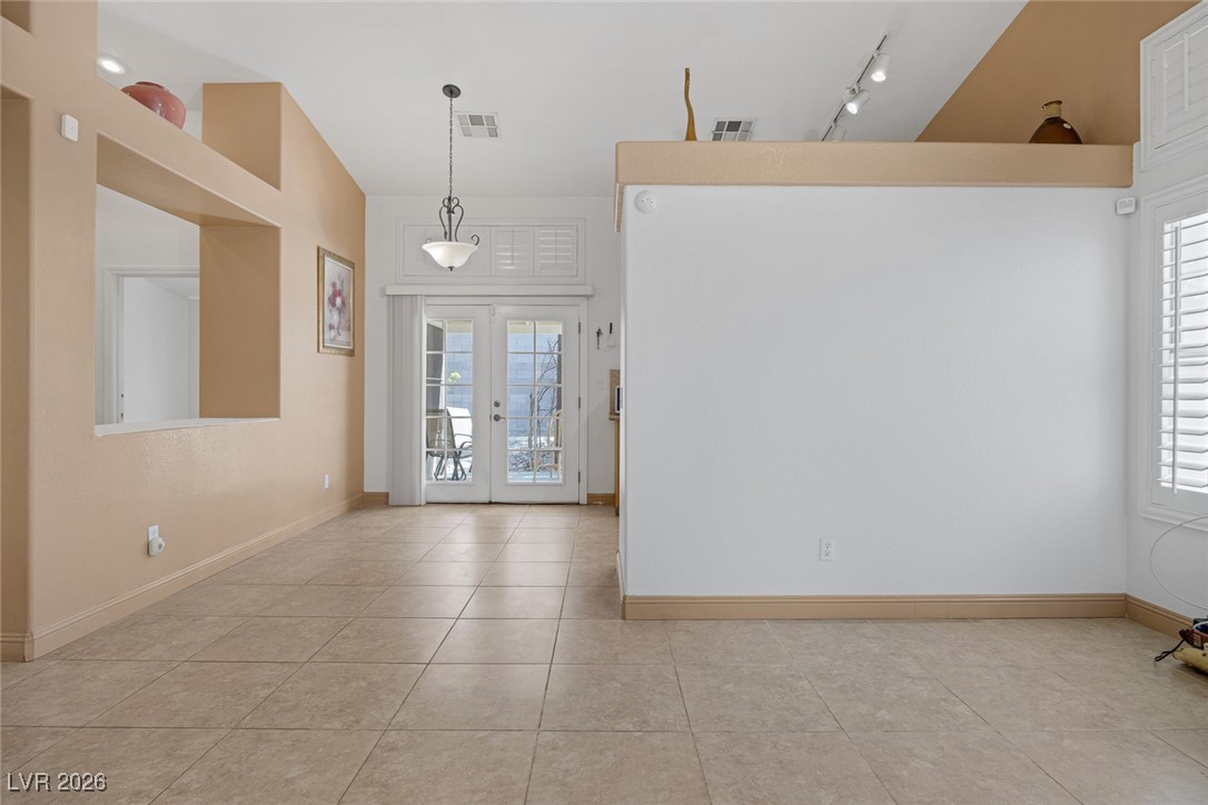 2427 Worchester Road Henderson, NV 89074 - Photo 7 of 35 Entryway featuring french doors, light tile patterned floors, and track lighting