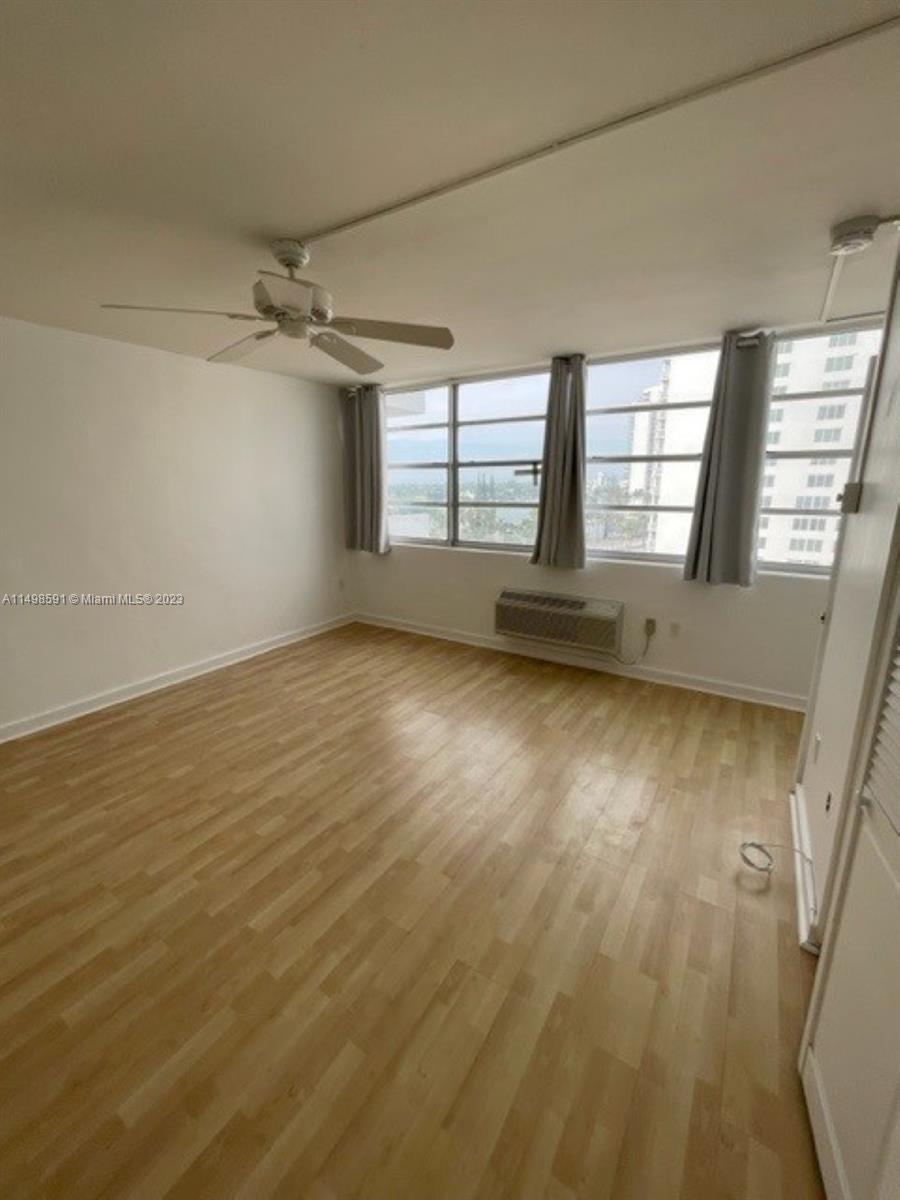Millionaire's Row Miami Beach, FL 33140 - Photo 15 of 16 wooden floor in an empty room with a window